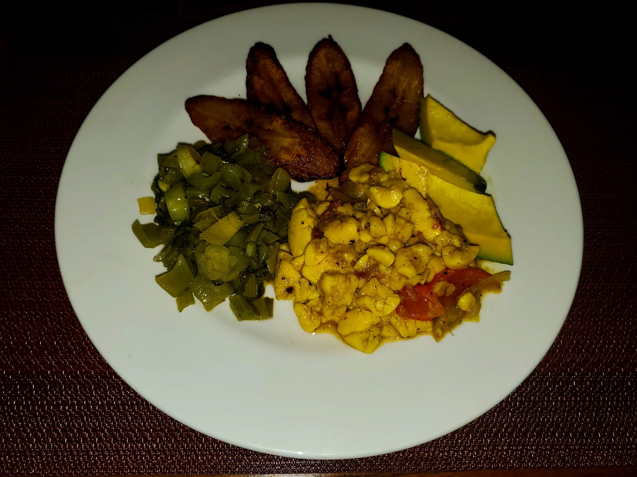 Ackee and saltfish served with vegetables